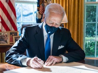 President Joe Biden signs a commission for Gina Raimondo as Secretary of Commerce Wednesday, March 3, 2021, in the Oval Office of the White House. (Official White House Photo by Adam Schultz)