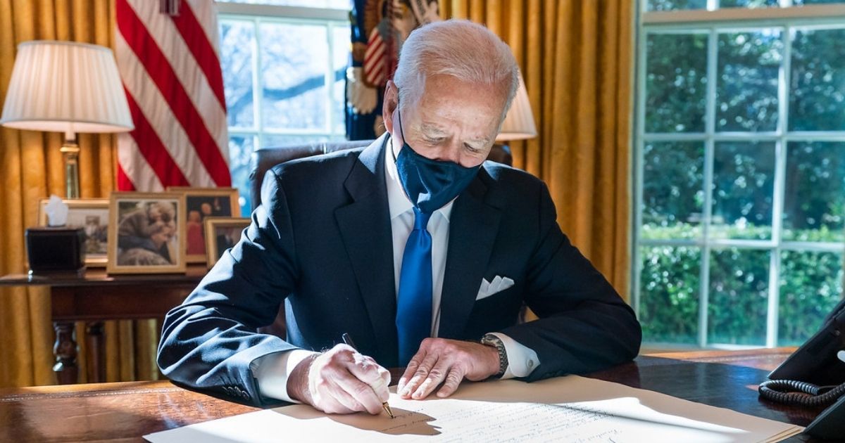 President Joe Biden signs a commission for Gina Raimondo as Secretary of Commerce Wednesday, March 3, 2021, in the Oval Office of the White House. (Official White House Photo by Adam Schultz)