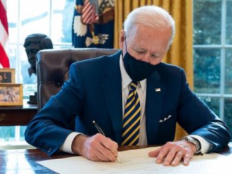 President Joe Biden signs the commission for Lloyd Austin to be Secretary of Defense Friday, Jan. 22, 2021, in the Oval Office of the White House. Lloyd Austin is the first black Secretary of Defense. (Official White House Photo by Adam Schultz)