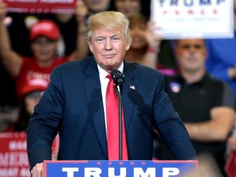 Donald Trump speaks with supporters at a campaign rally at the Phoenix Convention Center in Phoenix.