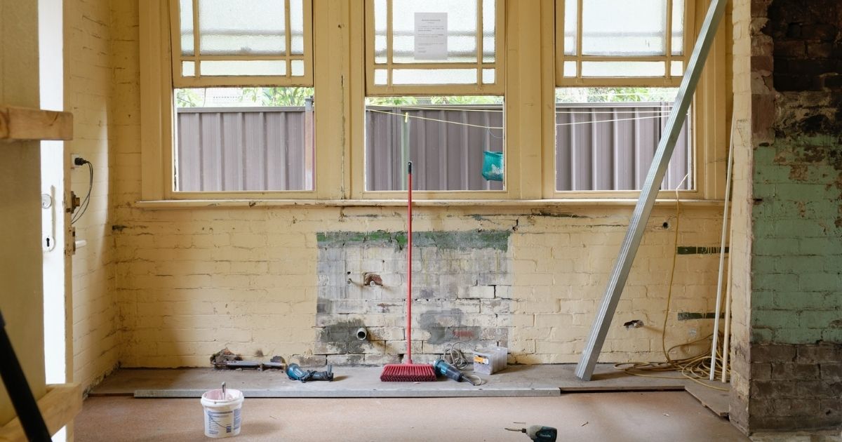 Unfinished wall in a house with painting paraphernalia