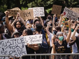 Crowd of protesters holding signs