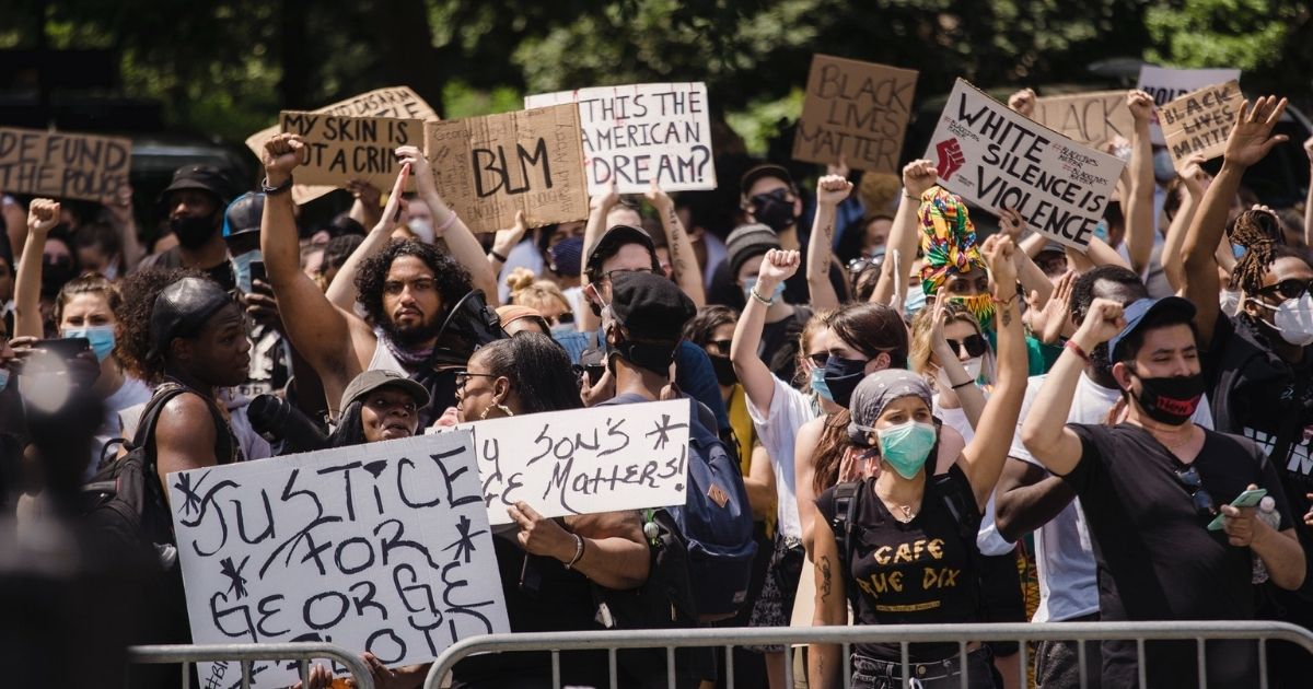 Crowd of protesters holding signs