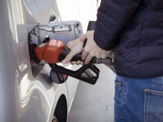 Person filling up car with gas