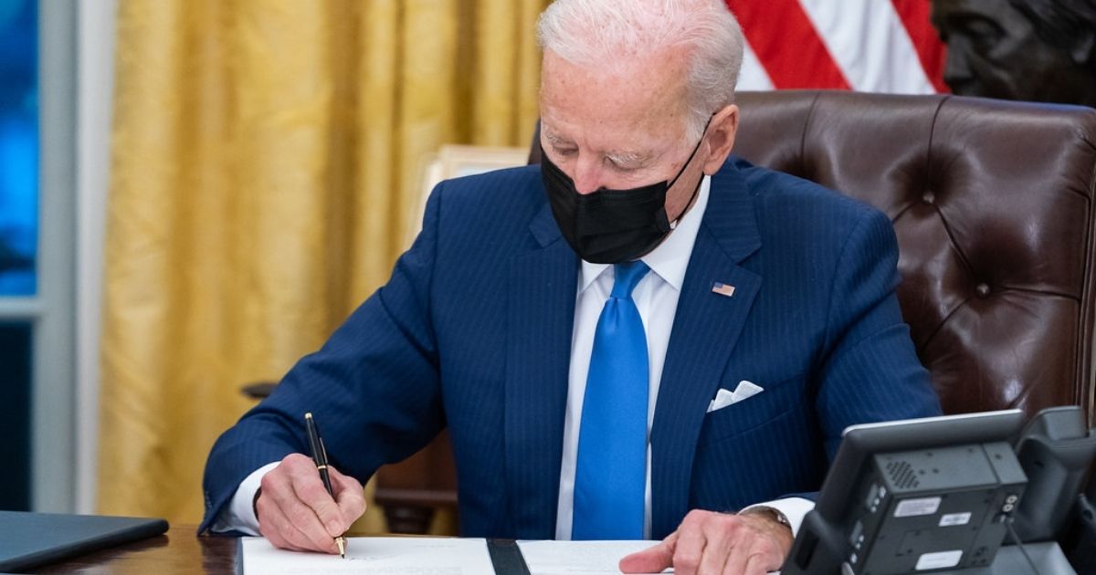 President Joe Biden signs executive orders on immigration Tuesday, Feb. 2, 2021, in the Oval Office of the White House. (Official White House Photo by Adam Schultz)