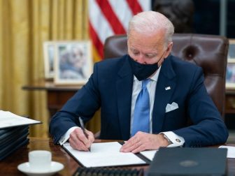 President Joe Biden signs one of the 17 Executive Orders he signed on Inauguration Day Wednesday, Jan. 20, 2021, in the Oval Office of the White House. (Official White House Photo by Adam Schultz)