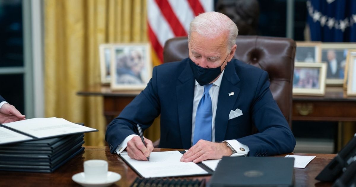 President Joe Biden signs one of the 17 Executive Orders he signed on Inauguration Day Wednesday, Jan. 20, 2021, in the Oval Office of the White House. (Official White House Photo by Adam Schultz)