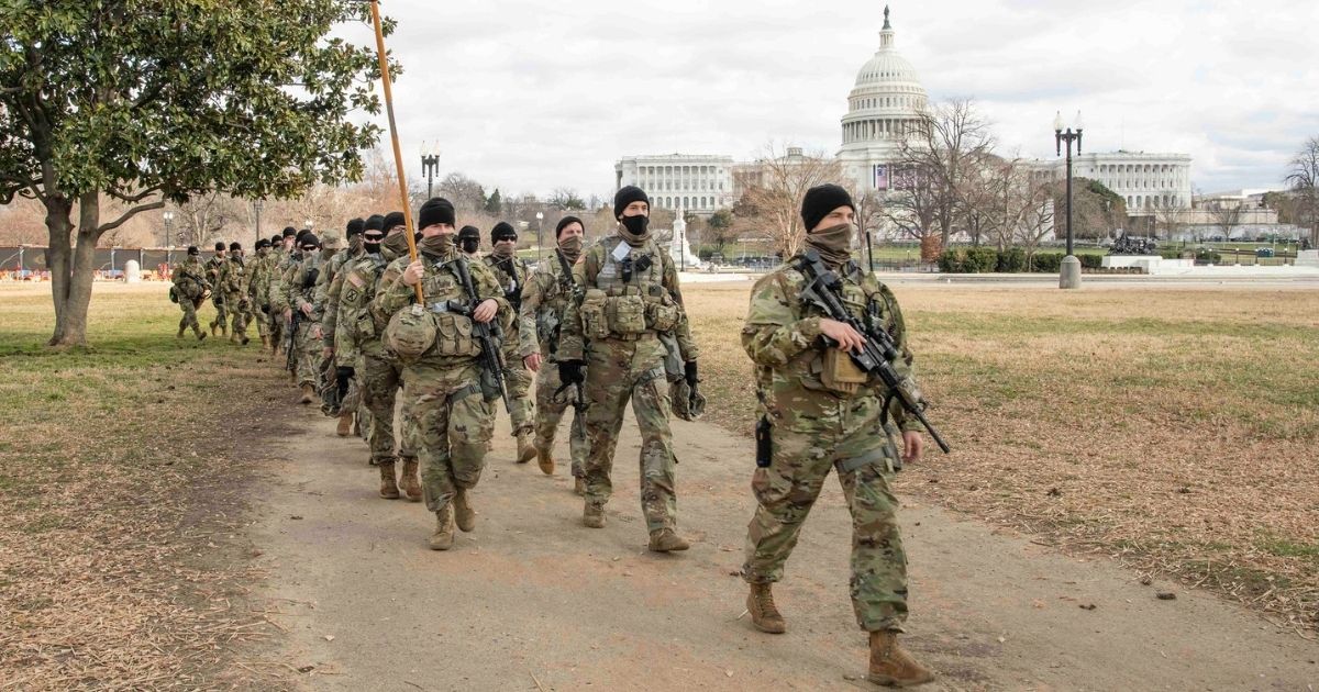 U.S. Army Soldiers assigned to the Virginia Army National Guard’s 1st Battalion, 116th Infantry Regiment, 116th Infantry Brigade Combat Team march to their posts near the U.S Capitol building Jan. 17, 2021, in Washington, D.C. At least 25,000 National Guard men and women have been authorized to conduct security, communication and logistical missions in support of federal and District authorities leading up and through the 59th Presidential Inauguration. (U.S. Air National Guard photo by Tech. Sgt. Lucretia Cunningham)