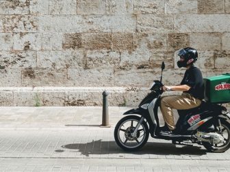 Delivery boy on the old streets of Valencia