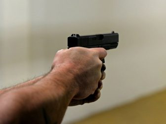 Man aiming a pistol.