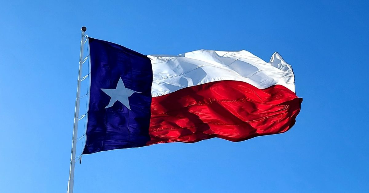 The Texas flag on a clear, windy day