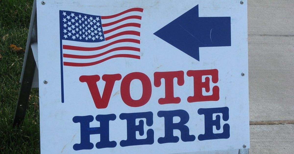 A vote sign sits in the above stock photo.