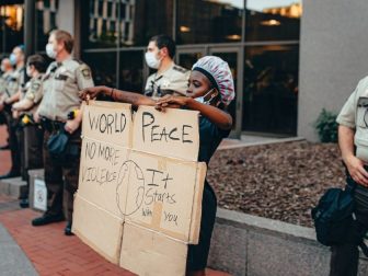 Woman protesting next to cops