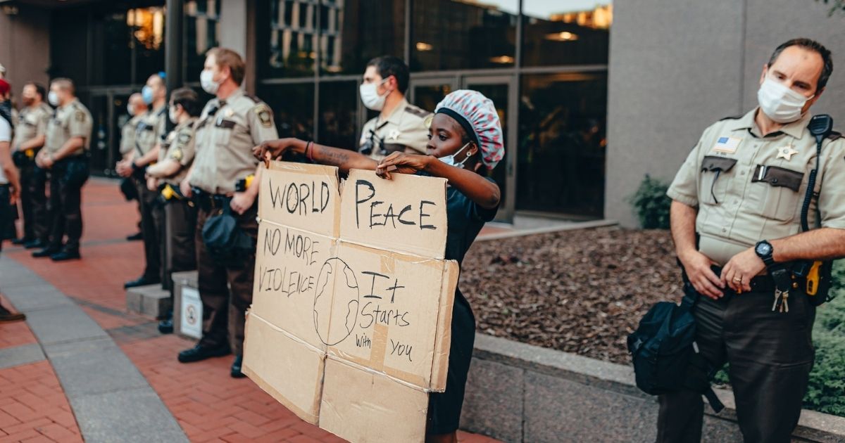 Woman protesting next to cops