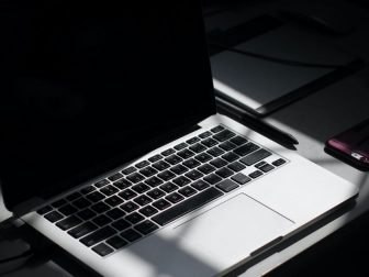 Laptop sitting on desk in the dark