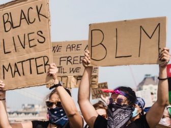Protestors holding BLM signs