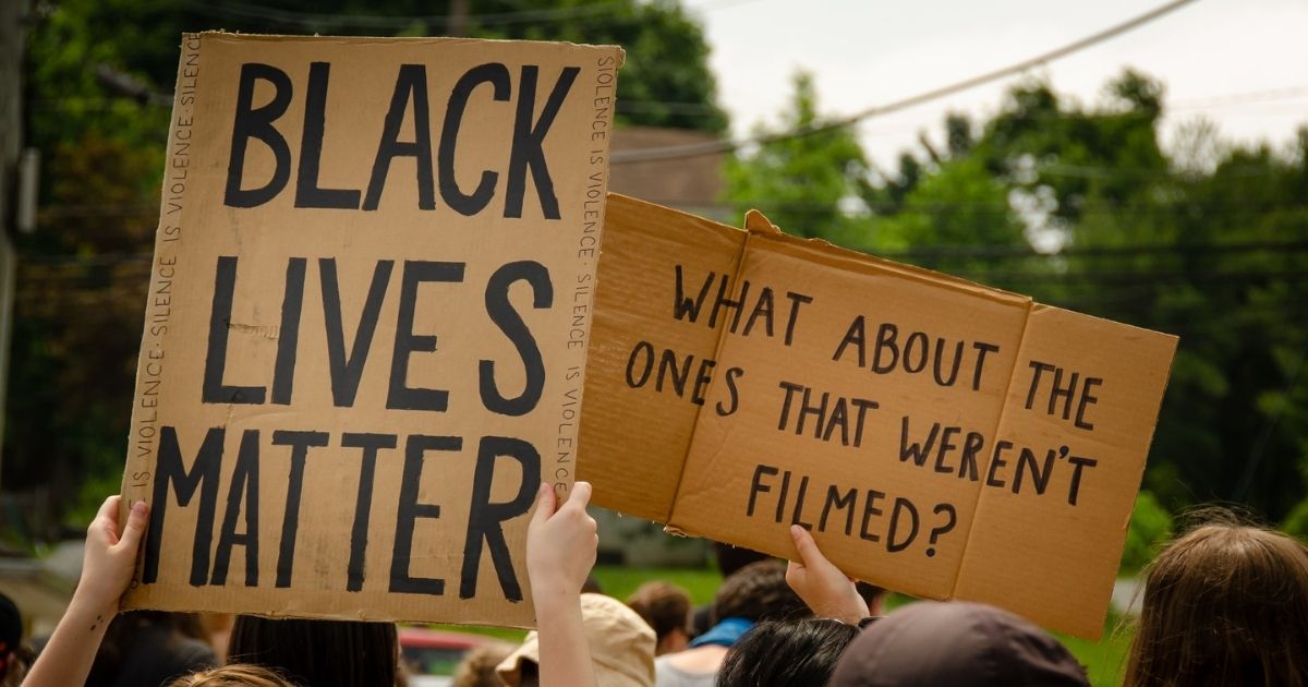 People holding BLM signs in protest