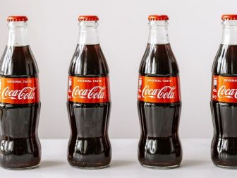 Four Cokes in glass bottles