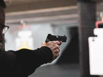 Person using a handgun at an indoor shooting range