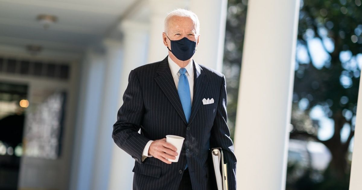 President Joe Biden walks with a cup of coffee Tuesday, March 2, 2021, along the Colonnade of the White House to the Oval Office. (Official White House Photo by Adam Schultz)