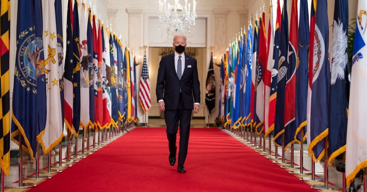 President Joe Biden walks from the State Dining Room of the White House to a podium in the Cross Hall of the White House Thursday, March 11, 2021, to deliver remarks on the one year anniversary of the COVID-19 Shutdown. (Official White House Photo by Adam Schultz)