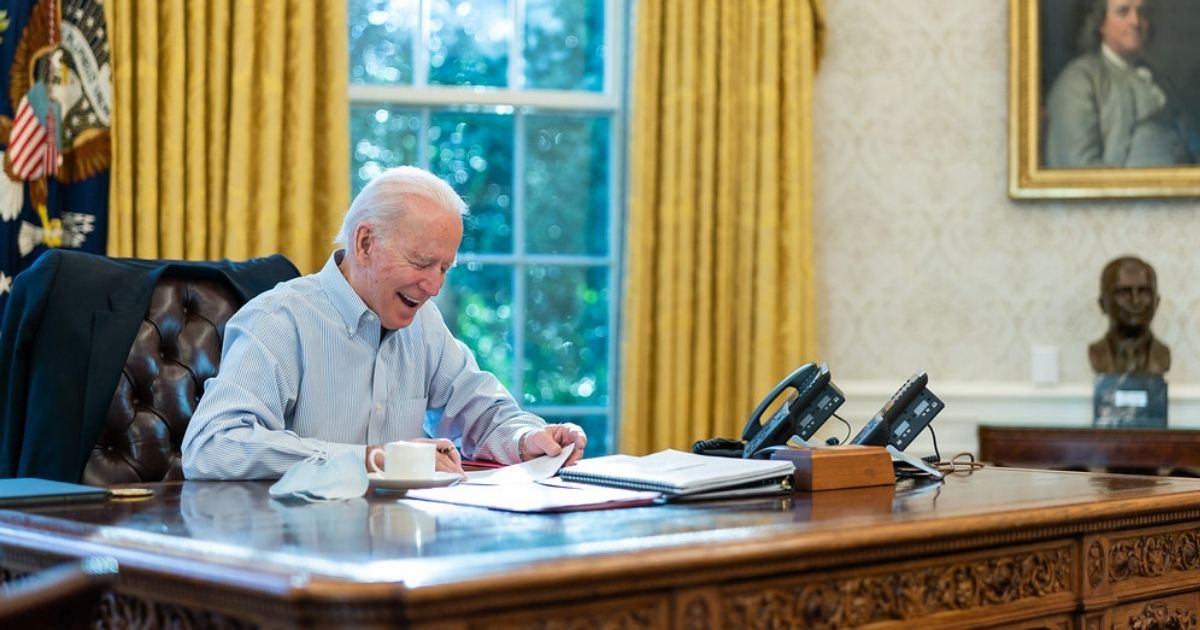 President Joe Biden talks on the phone with British Prime Minister Boris Johnson Saturday, Jan. 23, 2021, in the Oval Office of the White House. (Official White House Photo by Adam Schultz)