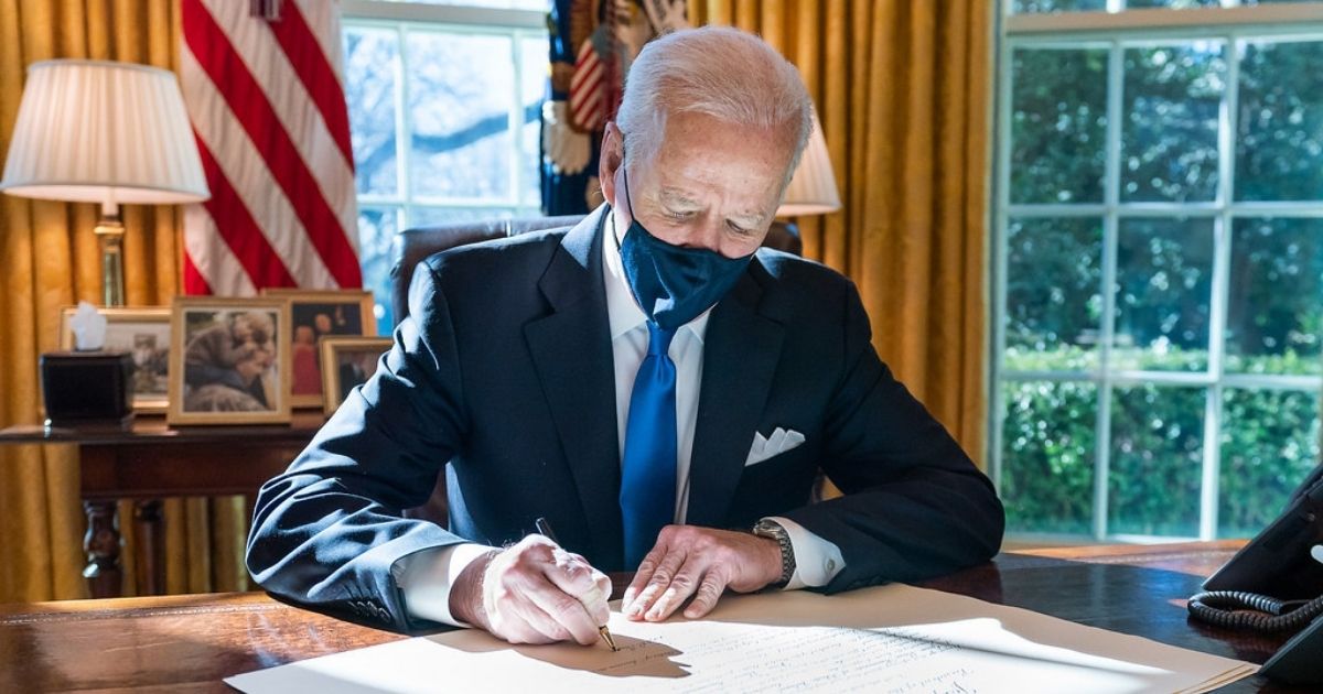 President Joe Biden signs a commission for Gina Raimondo as Secretary of Commerce Wednesday, March 3, 2021, in the Oval Office of the White House. (Official White House Photo by Adam Schultz)