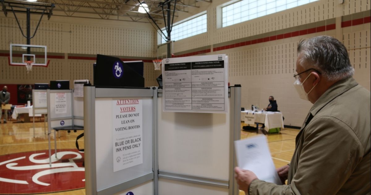 A voting booth is examined in Washington, D.C., on Nov. 3, 2020.