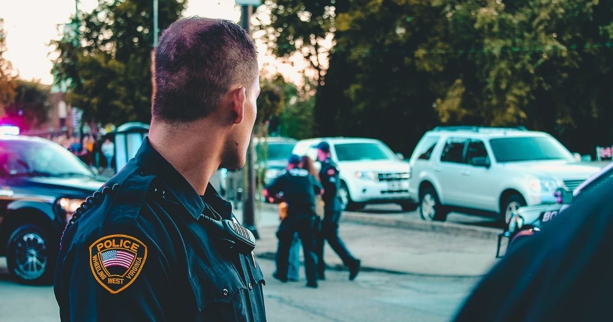 Police officer watching an arrest