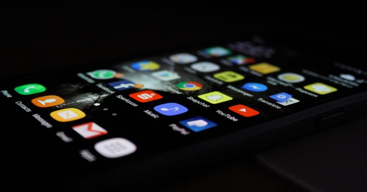 Phone in the dark displaying social media apps
