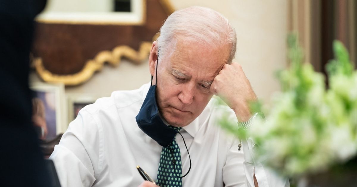 President Joe Biden takes notes during a briefing on the shootings in Atlanta Wednesday, March 17, 2021, in the Oval Office Dining Room of the White House. (Official White House Photo by Adam Schultz)