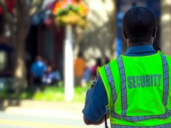 Security guard in neon green vest