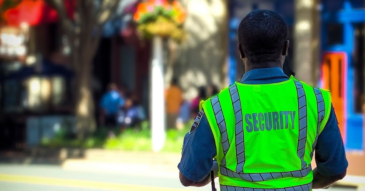 Security guard in neon green vest