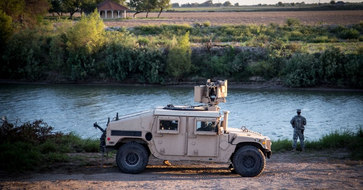 A soldier from the 36th Infantry Division, Texas Army National Guard observes a section of the Rio Grande River at sunset. He is serving at the Texas-Mexico border in support of Operation Strong Safety. (U.S. Army photo by Maj. Randall Stillinger)