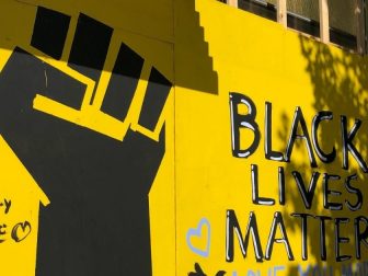 Black Lives Matter mural on a yellow wall