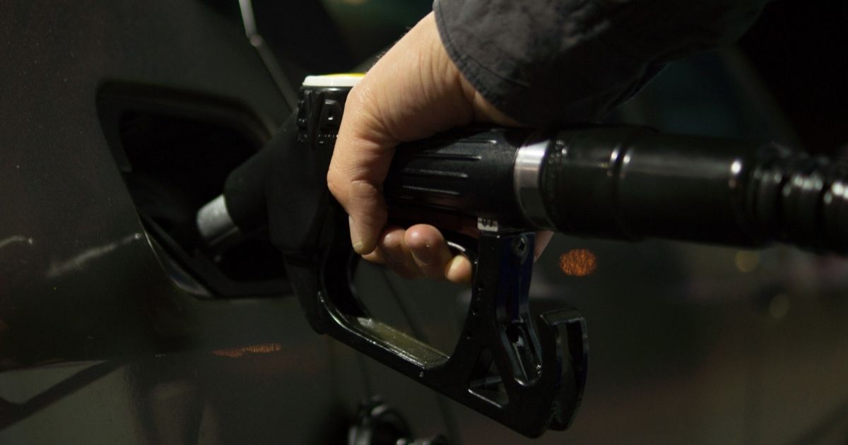 Hand holding a gas pump