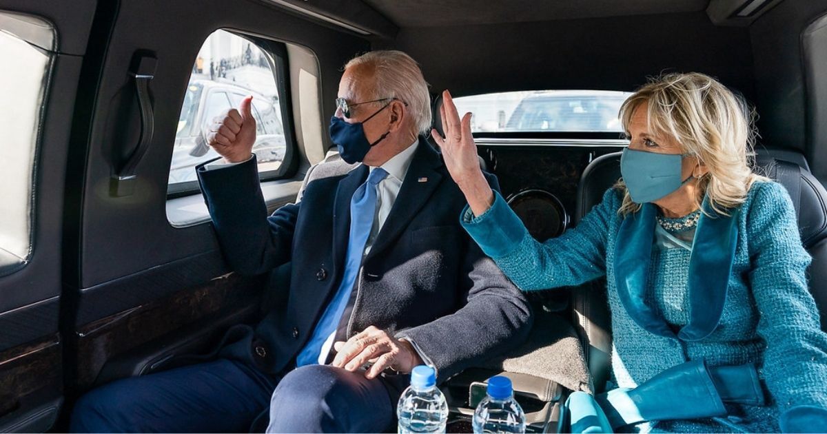 President Joe Biden and First Lady Dr. Jill Biden wave as they ride in the Presidential limousine Wednesday, Jan. 20, 2021, en route to Arlington National Cemetery in Arlington, Virginia. (Official White House Photo by Adam Schultz)
