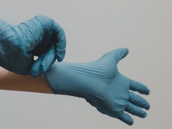 Hands with blue latex gloves on