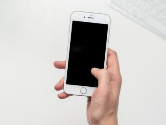 Hand holding an iPhone