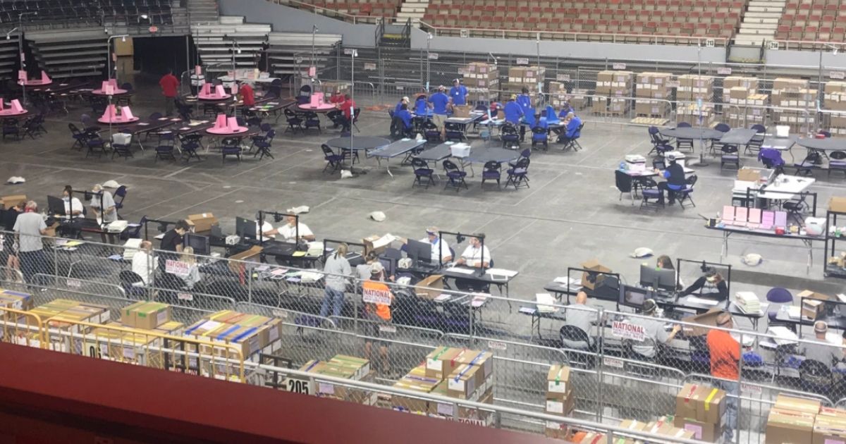 Workers conduct an audit of Maricopa County's 2020 general election in the Veterans Memorial Coliseum in Phoenix on Wednesday.