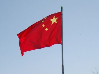 Chinese flag flying on a flag pole