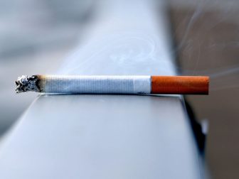 White cigarette on a handrail