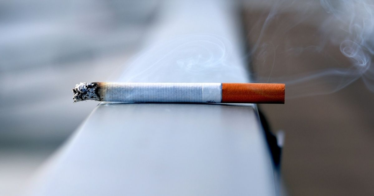 White cigarette on a handrail