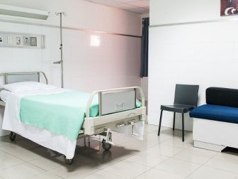 Hospital bed with a couch beside it