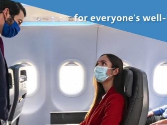 American Airlines releases a promotion video featuring a masked flight attendant speaking with a masked traveler aboard a flight.