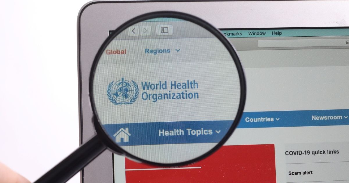 WHO World Health Organization website under magnifying glass