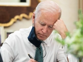 President Joe Biden takes notes during a briefing on the shootings in Atlanta Wednesday, March 17, 2021, in the Oval Office Dining Room of the White House.