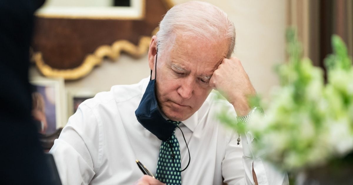 President Joe Biden takes notes during a briefing on the shootings in Atlanta Wednesday, March 17, 2021, in the Oval Office Dining Room of the White House.