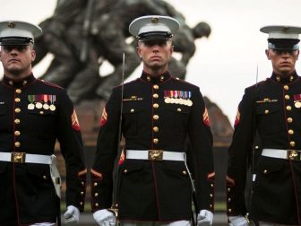 Three noncommissioned officers from Marine Barracks, Washington at 8th & I, perform during a Tuesday Sunset Parade at the Marine Corps War Memorial in Arlington, Va., July 30, 2013. There are seven companies with various sections that comprise Marine Barracks Washington, the U.S. Marine Band, the U.S. Marine Drum & Bugle Corps, Guard Company, Company A, Company B, Headquarters & Service Company, and Marine Corps Institute Company.