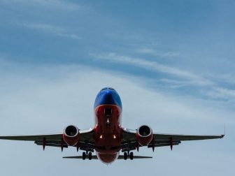 Red and blue airplane against a blue sky